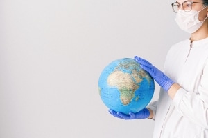 Nurse holding a globe