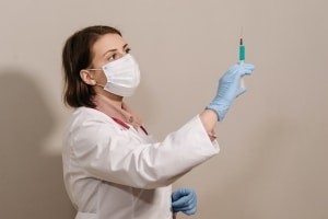 Medical professional holding a syringe