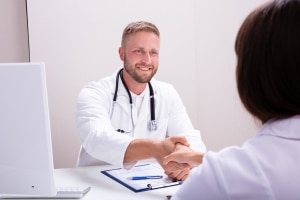 Health professional shaking a woman's hand