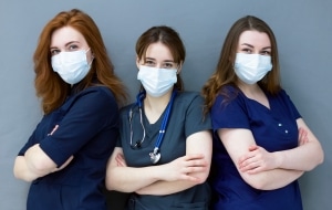 Trio of young masked nurses