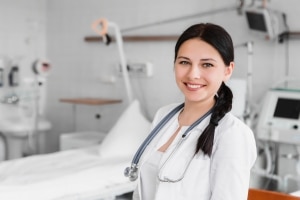 Nurse standing in front of a hospital bed