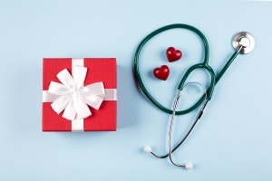 Stethoscope and present on blue background