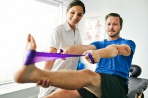 Physical therapy session with a patient using a band