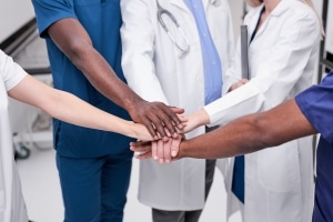 Medical professionals touching hands