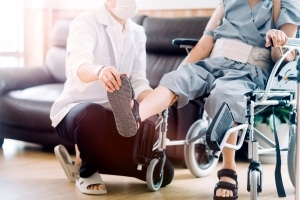 Physical Therapist Assistant manipulating a man's foot