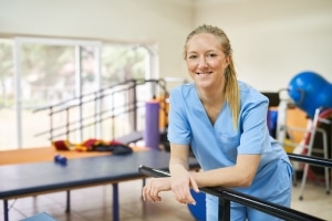 Smiling physical therapist assistant