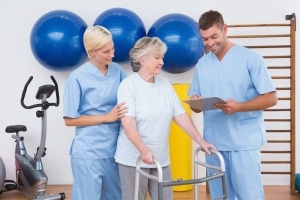 Physical therapy team with a patient