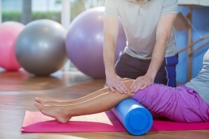 Physical Therapist Assistant manipulating a patient's legs