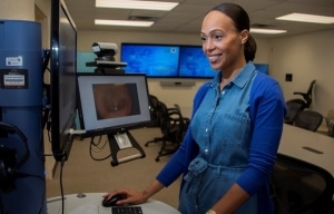 Smiling female professional on a computer